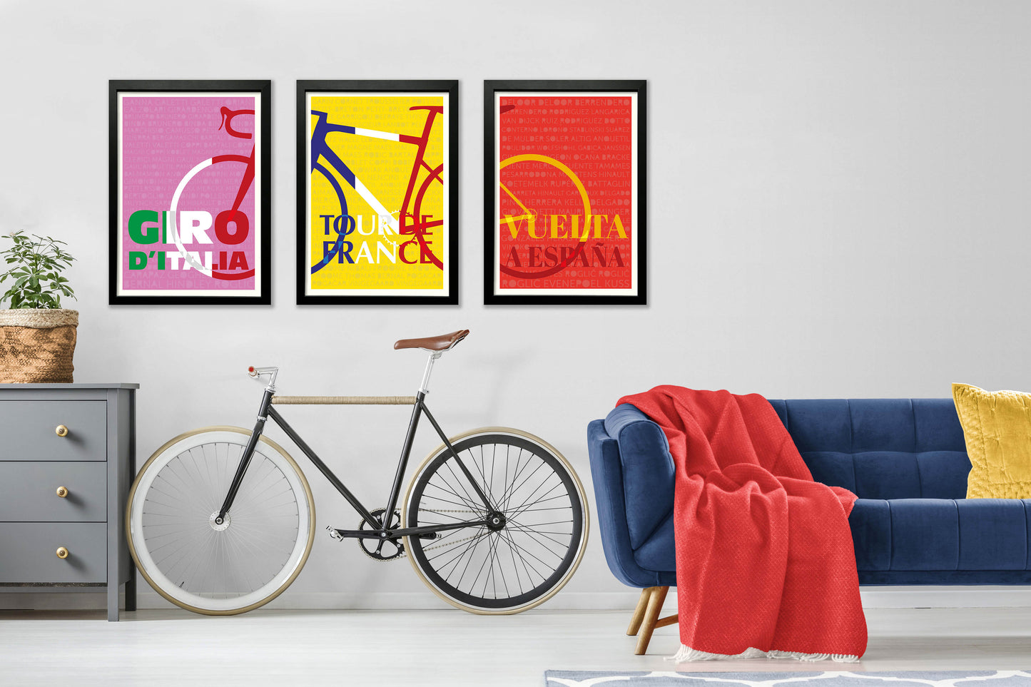 Set of 3 grand Tour prints in a black frame on the wall. Giro-d-Italia, Tour de France and Vuelta a Espana.