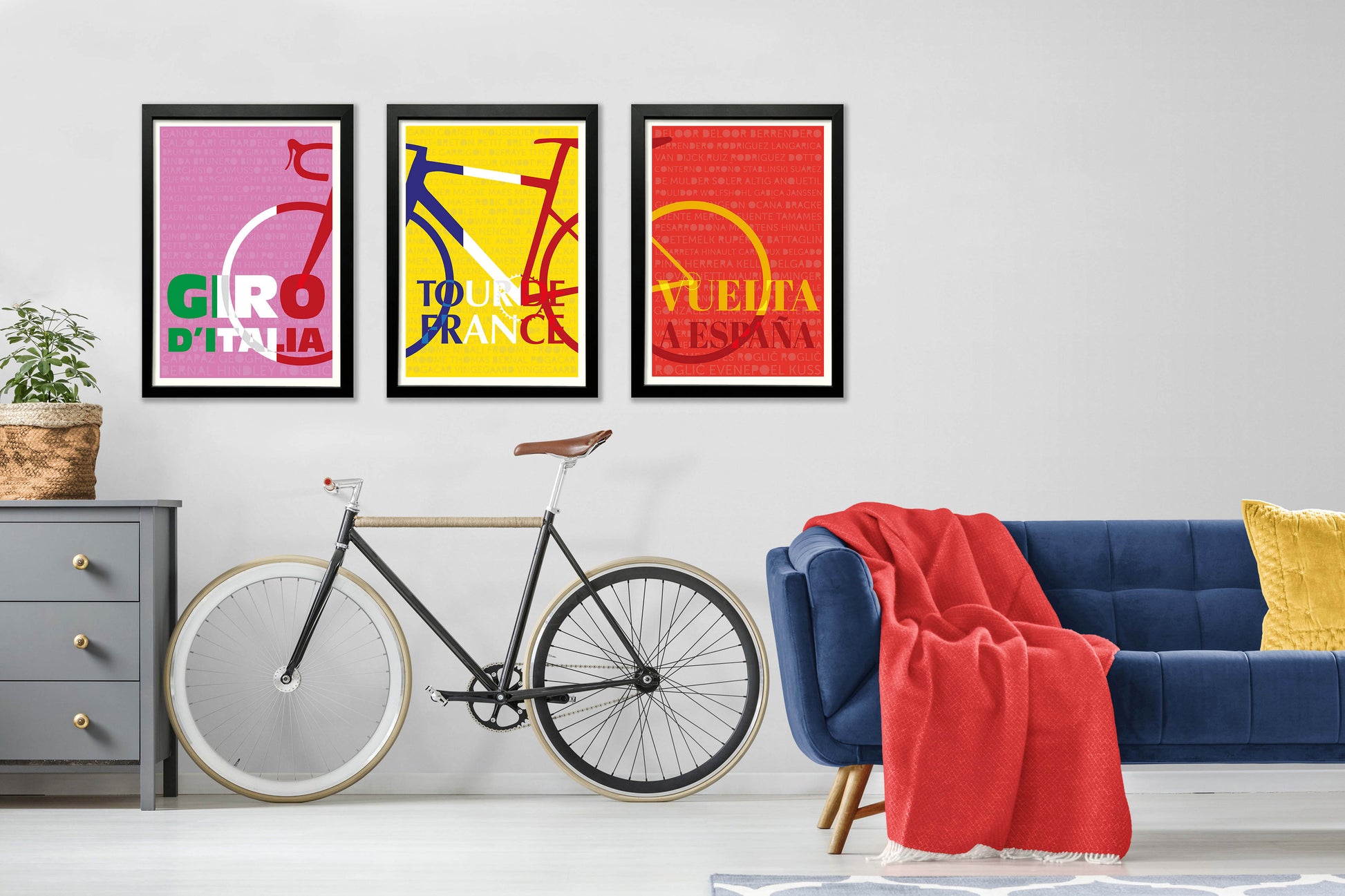 Set of 3 grand Tour prints in a black frame on the wall. Giro-d-Italia, Tour de France and Vuelta a Espana.