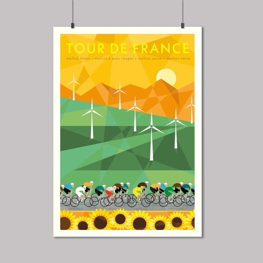 Cycling print of the Tour de France peloton racing past a field of windmills and sunflowers with mountains in the background. The yellow jersey can be seen in the group.